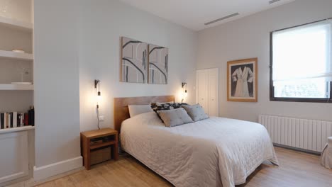 Slow-revealing-shot-of-a-modern-white-master-bedroom-with-a-small-library