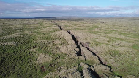 Aerial-view-of-a-large-crack-in-the-ground-between-two-tectonic-plates-in-a-volcanic-rift-zone-in-Iceland