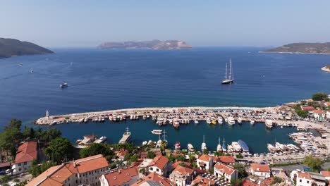 Aerial-dolly-of-Kas,-Antalya,-showing-the-coastal-town-with-blue-waters,-boats,-and-surrounding-hills-in-Turkey