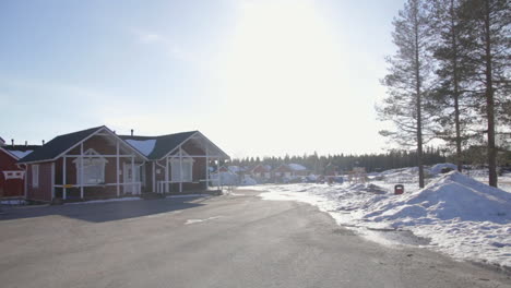 Cozy-red-cottages-under-a-clear-winter-sky-in-Santa-Claus-Holiday-Village-Rovaniemi-Finland