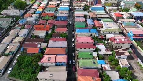 Colorful-residential-neighborhood-rooftops-and-narrow-street-with-parked-cars