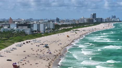 Expansive-view-of-South-Beach’s-coastline-with-sunbathers-along-the-sandy-shore