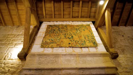 Elegant-Fireplace-with-carpet-decoration-at-the-stone-wall-in-a-french-chateau