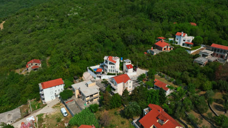 Aerial-view-tilting-over-homes-in-the-hills-of-Herceg-Novi,-in-sunny-Montenegro