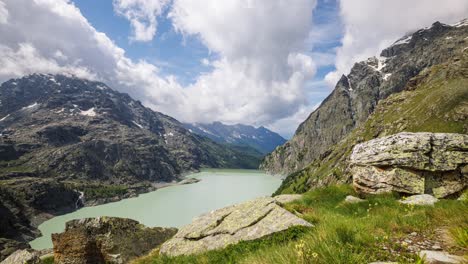 Timelapse-video-of-the-scenic-Diga-dell'Alpe-Gera-in-the-Italian-Alps,-showcasing-serene-mountain-views,-a-turquoise-lake