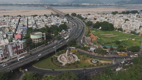 An-aerial-video-of-Vijayawada,-a-thriving-city-highlights-its-dynamic-urban-landscape,-including-the-picturesque-Krishna-River