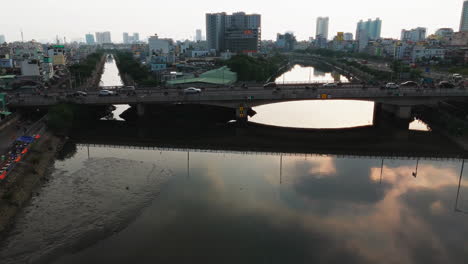 A-breathtaking-aerial-shot-captures-a-bustling-city-bridge-bathed-in-the-warm-glow-of-the-setting-sun