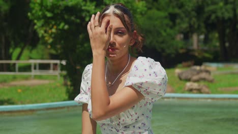 A-girl-in-a-light,-flowing-dress-wanders-through-a-tropical-park-on-a-sunny-day