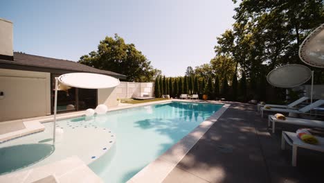 push-in-shot-of-a-pool-area-in-the-backyard-of-a-luxury-home