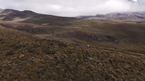 Travelers-hiking-near-the-base-of-Chimborazo-Mountain,-Ecuador