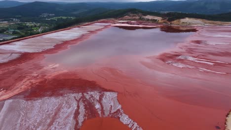 Reflections-On-Waters-Of-Red-Mud-Pond-At-Alcoa-Reservoir-In-Lugo,-Spain