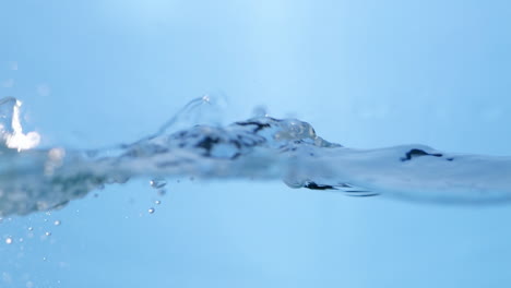 Stunning-close-up-shot-of-clean-water-surface-in-slow-motion,-featuring-vibrant-blue-waves-that-symbolize-purity-and-freshness-for-beverage-related-content