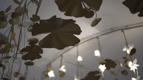 decorative-metal-leaf-installation-with-soft,-glowing-lights,-creating-a-warm-and-artistic-ambiance-in-a-dimly-lit-room