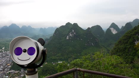 Viewpoint-with-panda-bear-scope-to-see-karst-mountain-range-and-Xingping-Old-Town,-China