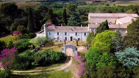 Aerial-establishing-shot-of-Cieurac-Castle-with-a-archway-over-the-entrance