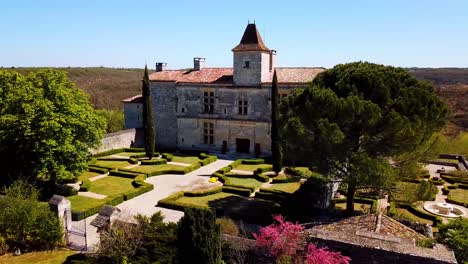 Aerial-establishing-shot-of-Cieurac-Castle-with-beautiful-gardens-at-summer