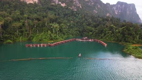 4K-drone-video-of-a-boat-sailing-towards-the-floating-bungalows-in-Khao-Sok-National-Park