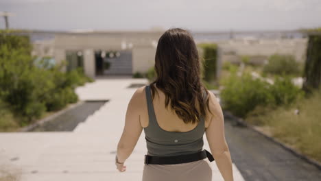 Slow-motion-bokeh-shot-of-a-female-tourist-walking-through-the-streets-of-Santorini