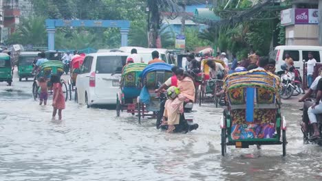 Rickshaws-and-street-children-flooded-city-Bangladesh,-South-Asia-monsoon-season