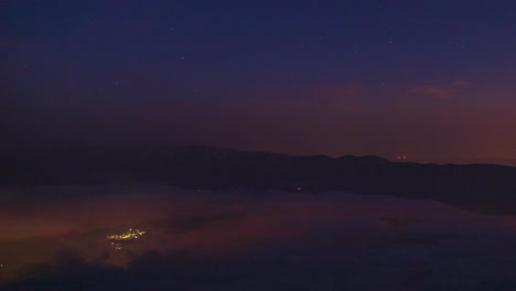 Experience-twilight-glow-from-an-airplane-flying-high-above-illuminated-city-lights-with-stunning-aerial-views-of-Iran-Saudi-Arabia-Emirates-under-night-sky-twilight-mountain-landscape-tehran