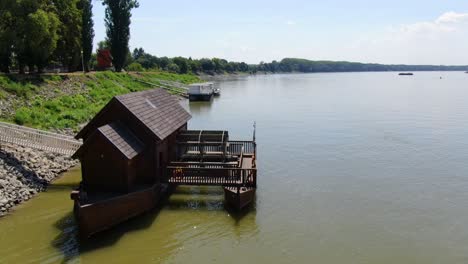 Traditional-Watermill-boat-navigating-the-Danube-in-Baja,-Hungary