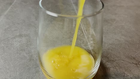 Fresh-orange-juice-being-poured-into-a-glass,-capturing-the-vibrant-and-refreshing-nature-of-this-vitamin-rich-citrus-drink