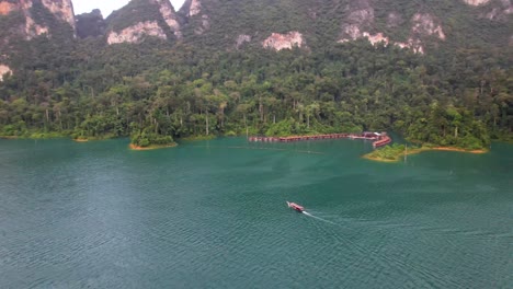 4K-drone-video-panning-around-a-boat-sailing-around-Khao-Sok-National-Park-in-Thailand