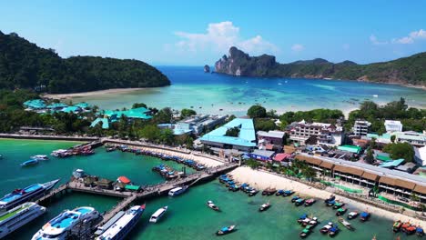 Kho-Phi-phi-island-tonsai-pier-boats-arrive-docked-on-turquoise-water-on-a-sunny-day-in-thailand