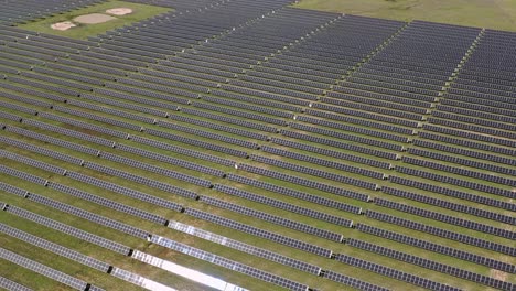 4K-drone-footage-of-an-Australian-solar-farm,-showcasing-rows-of-solar-panels-harnessing-clean-energy