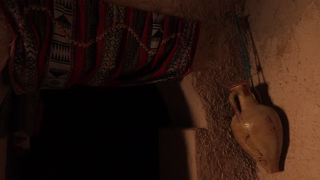 Ancient-Tunisian-house-interior-with-traditional-decor-and-earthen-walls,-warm-lighting-at-dusk