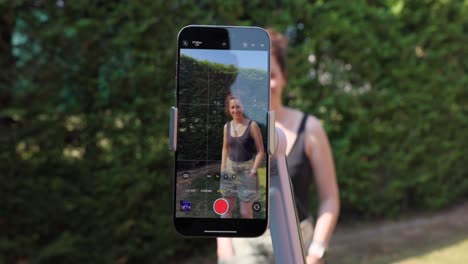 Woman-Outdoor-Recording-Video-With-Smartphone-Mounted-On-AI-Tracking-Gimbal-Stabilizer