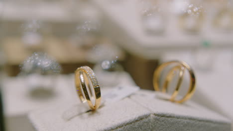 Gold-Rings-with-Precious-Stones-Rotating-in-a-Shop-Window