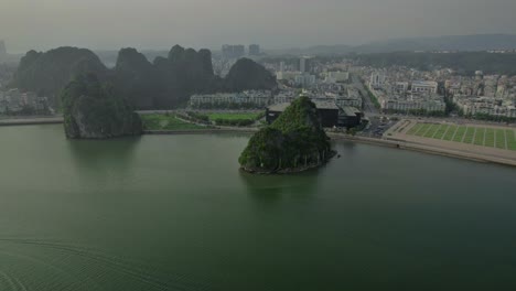 Aerial-view-of-Ha-Long-Town,-showcasing-the-coastal-buildings-on-a-gloomy-day,-with-the-cityscape-stretching-along-the-shore