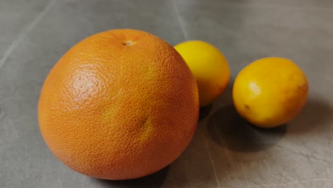 A-close-up-of-an-orange-and-two-lemons-showcasing-vibrant,-fresh-citrus-fruits