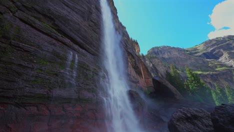 Telluride-close-up-water-Bridal-Veil-Falls-Waterfall-Box-canyon-view-Colorado-landscape-pan-down-slowly-mist-spray-Box-Canyon-cliffside-4wd-hiking-Black-Bear-Pass-Board-sunny-blue-sky-shaded