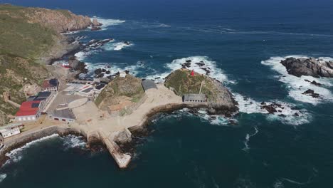 Aerial-view-of-the-stunning-landscape-of-Quintay-Museum-Foundation,-Ex-Ballenera-Museum,-set-against-the-rugged-Chilean-coastline-in-Valparaíso,-Chile