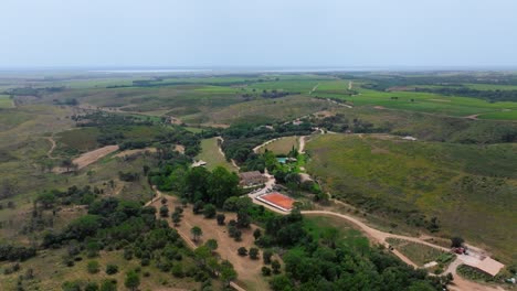 Aerial-orbiting-shot-of-a-villa-with-a-tennis-court-in-the-French-countryside