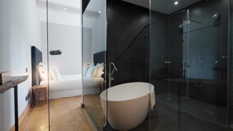 Interior-design-of-a-stylishly-decorated-house-at-Domaine-Sainte-Colombe,-France,-featuring-a-glass-ceiling-washroom-with-a-nearby-bedroom,-ideal-for-concepts-of-modern-luxury-and-seamless-elegance