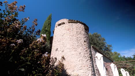 Slow-establishing-shot-of-a-stone-tower-on-a-villa-in-Goult,-France