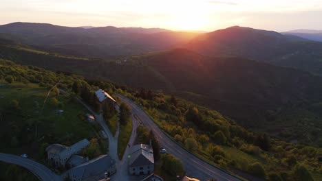 Aerial-pullback-from-sunset-natural-scenery-revealing-small-town-of-Cebreiro,-Lugo