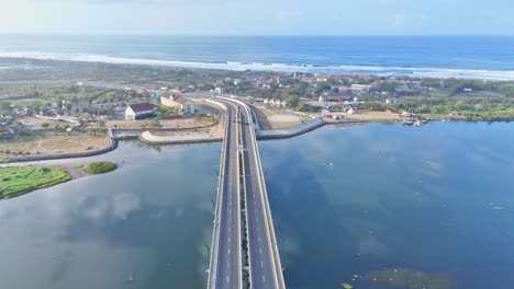 Modern-highway-bridge-and-ocean-coast-in-Indonesia,-aerial-view