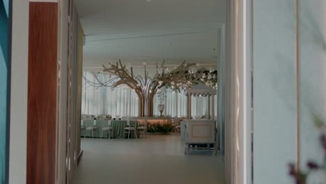 View-of-a-beautifully-decorated-wedding-reception-hall-with-tree-like-decor-and-elegant-seating-arrangements