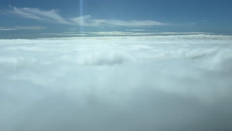 Immersive-pilot-POV-FPV-flying-over-a-sea-of-clouds-with-the-sun-shining-ahead