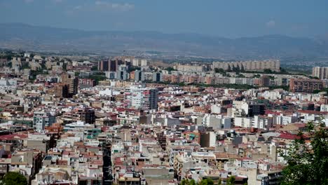 An-aerial-view-of-Alicante,-Spain,-reveals-a-sprawling-cityscape,-blending-modern-and-old-buildings,-with-homes-nestled-among-historic-and-contemporary-architecture