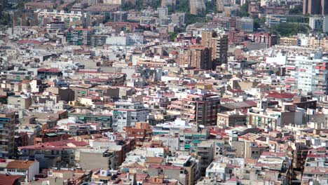 A-top-view-of-a-crowded-cityscape,-featuring-tightly-packed-homes-and-architectural-buildings,-predominantly-white,-creating-a-uniform-and-suffocating-urban-landscape