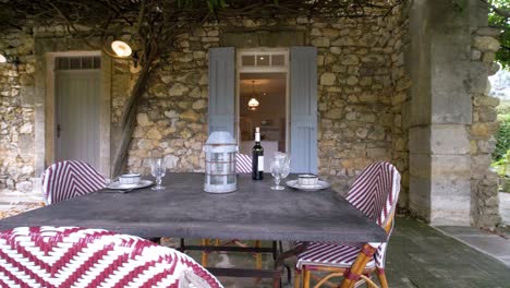 Slow-orbiting-shot-of-a-set-garden-table-outside-of-a-villa-in-France