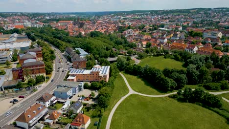 4K-Aerial-Drone-Video-of-Rezatparkplatz-West-Parking-Lot-on-the-Frankische-Rezat-River-in-Ansbach,-Germany