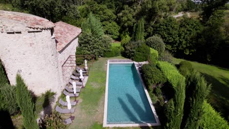 Aerial-establishing-shot-of-a-tropical-swimming-pool-in-the-garden-of-a-villa