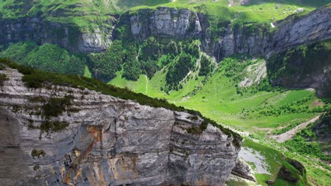 4k-Drone-Aerial-Pan-Shot-Of-Jagged-Slanted-Rock-Structure-With-Seealpsee-Lake-At-Shäfler-Ridge-In-Appenzell-Region-Of-Switzerland