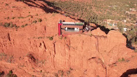 Aerial-View-of-Futuristic-House-With-Solar-Panels-Atop-Red-Sandstone-Cliff-in-Landscape-of-Sedona-Arizona-USA